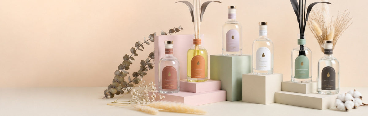 Reed diffusers styled on pastel pedestals with dried flowers