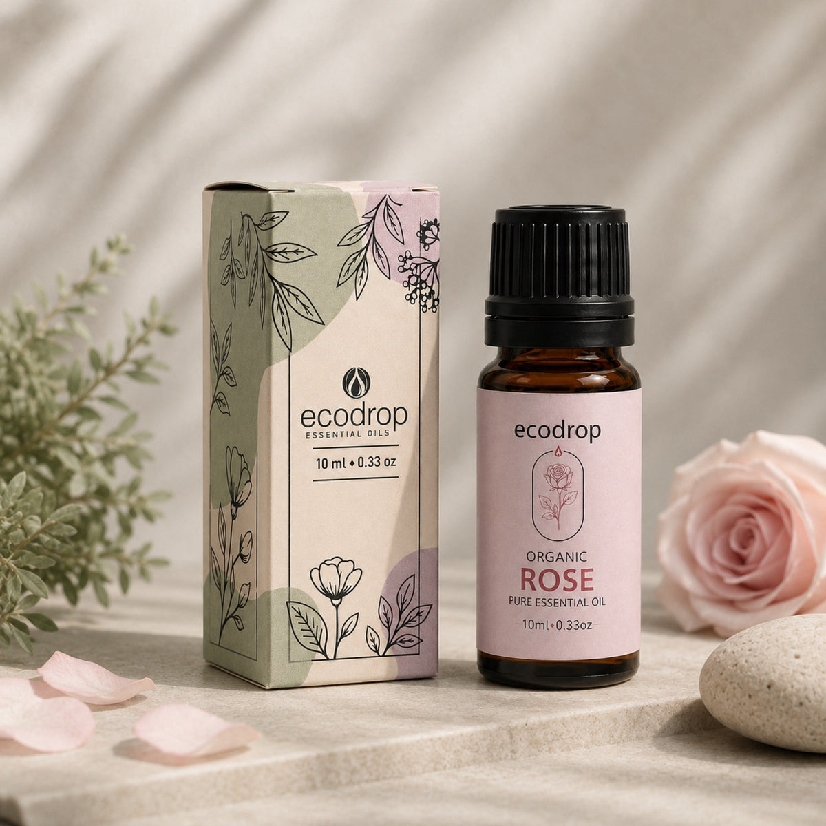 Organic Rose essential oil styled with rose petals, soft pink setting