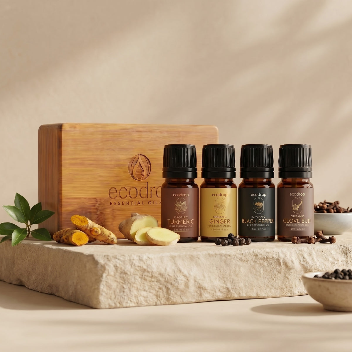 Turmeric, ginger, black pepper and clove bud essential oils on stone with fresh spices