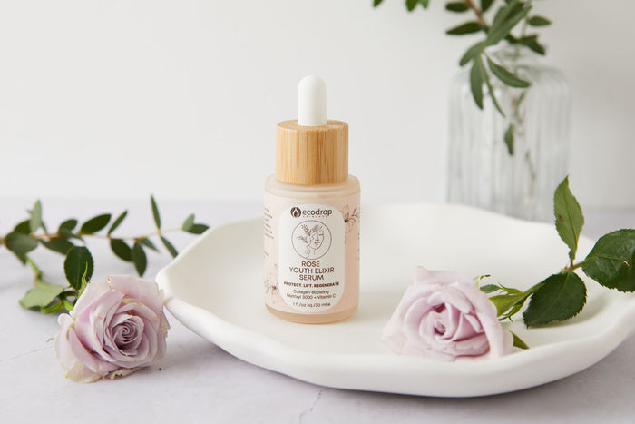 Ecodrop Rose Youth Elixir Serum bottle with pink roses and botanical foliage