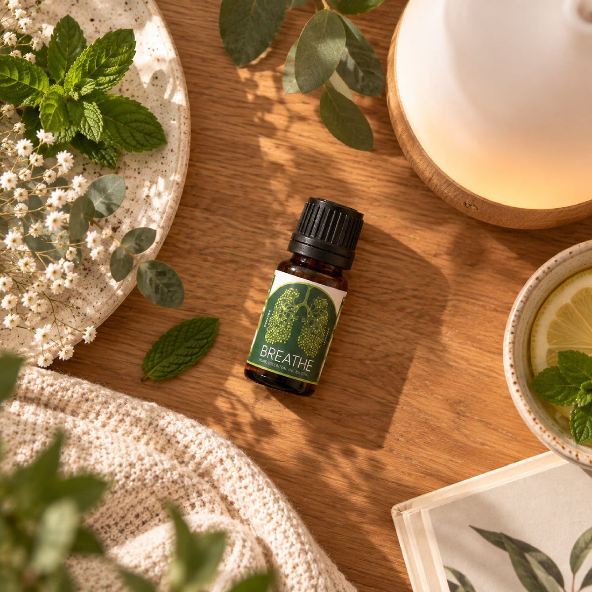 Fresh mint, eucalyptus and the Breathe Easy blend on a wooden table