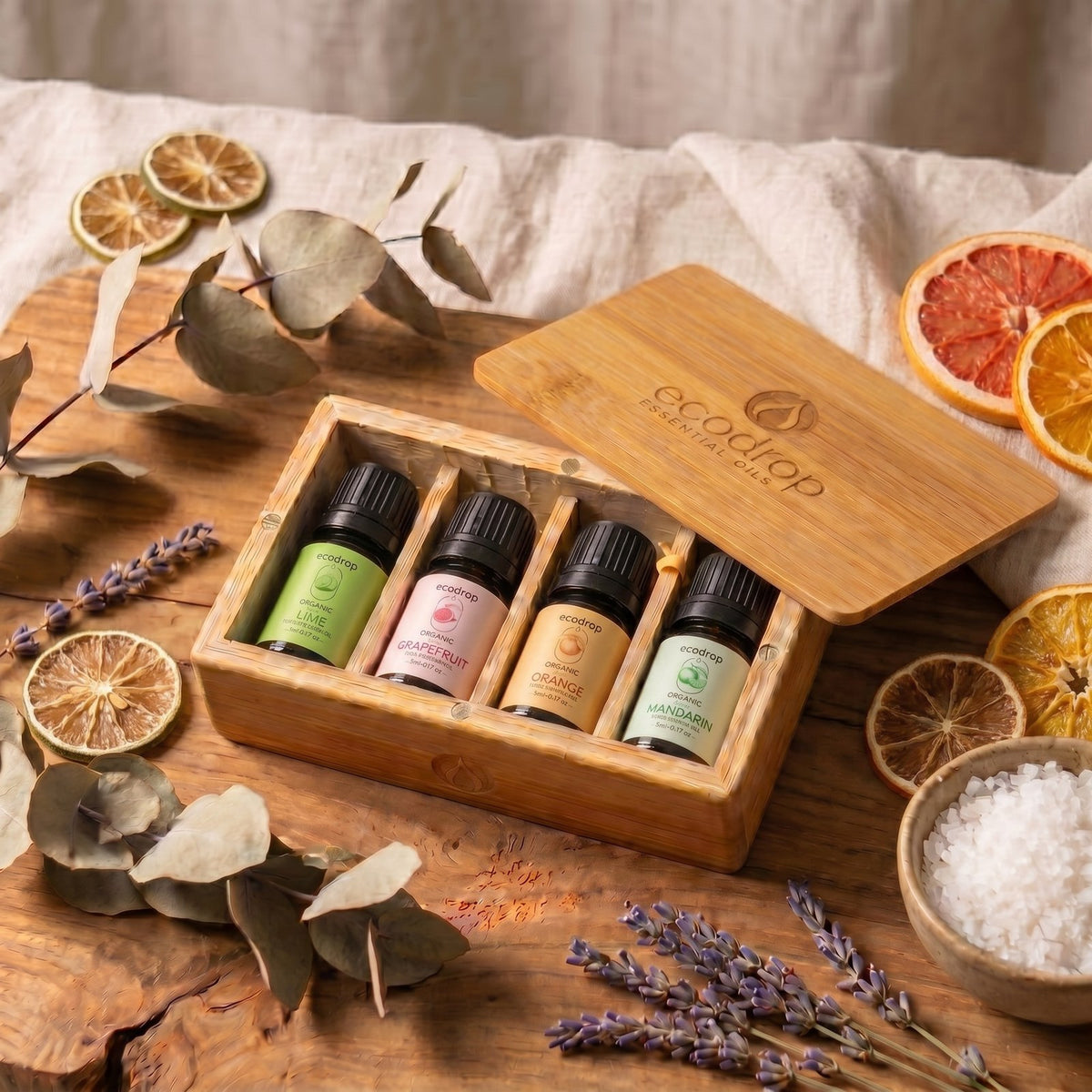 Citrus essential oil gift box on wood with dried orange slices, eucalyptus and lavender