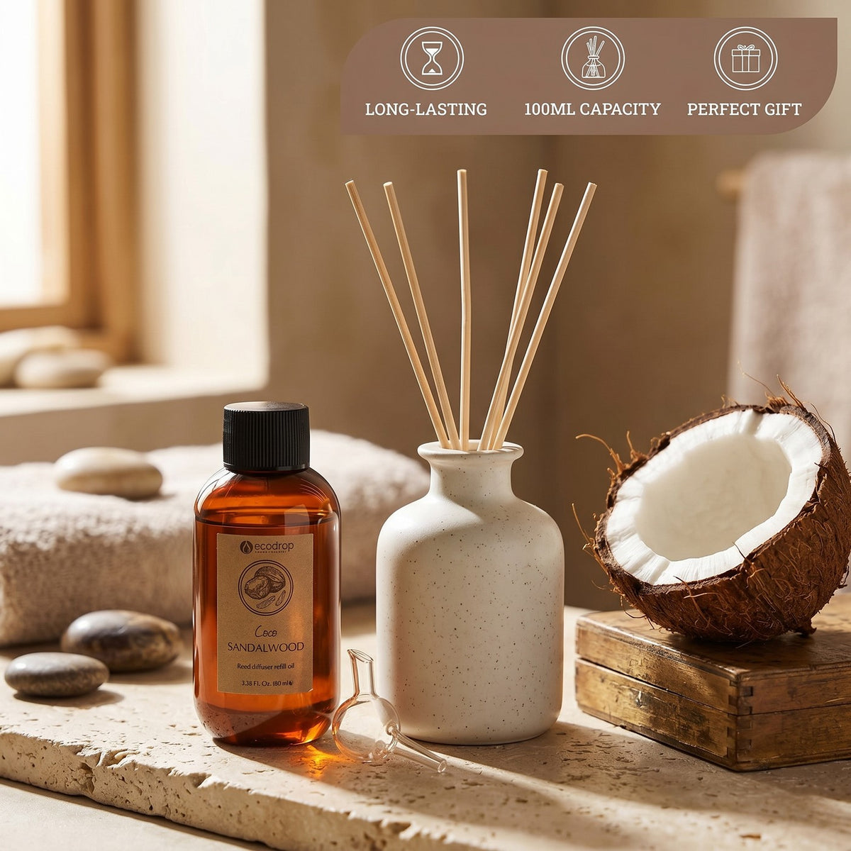 Coco Sandalwood reed diffuser in a spa setting with coconut, stones and towel