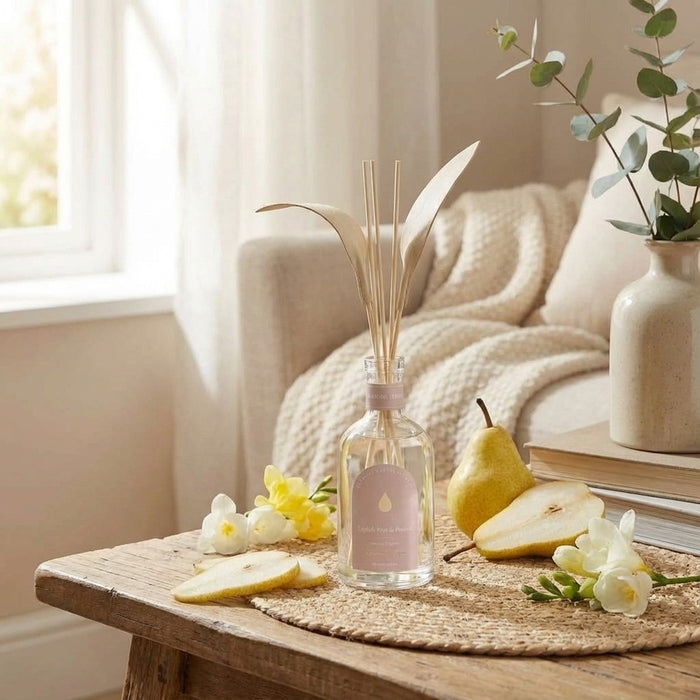 English Pear & Freesia diffuser styled on a table by a window