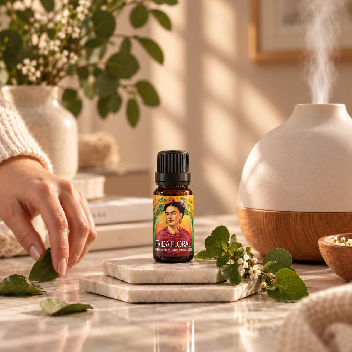 Frida Floral blend on a marble coaster beside a misting diffuser