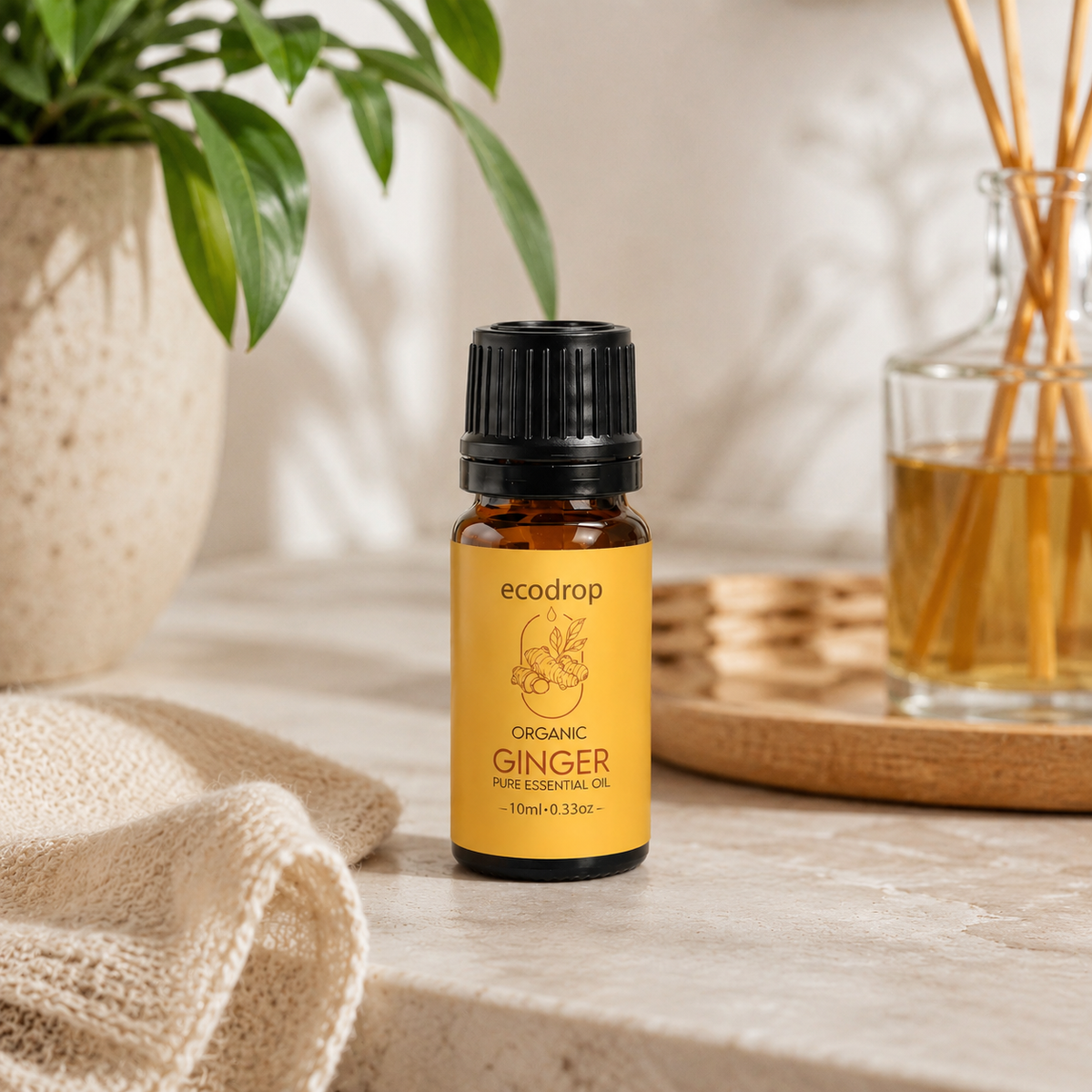 Ecodrop organic ginger essential oil beside a reed diffuser in a warm, sunlit room