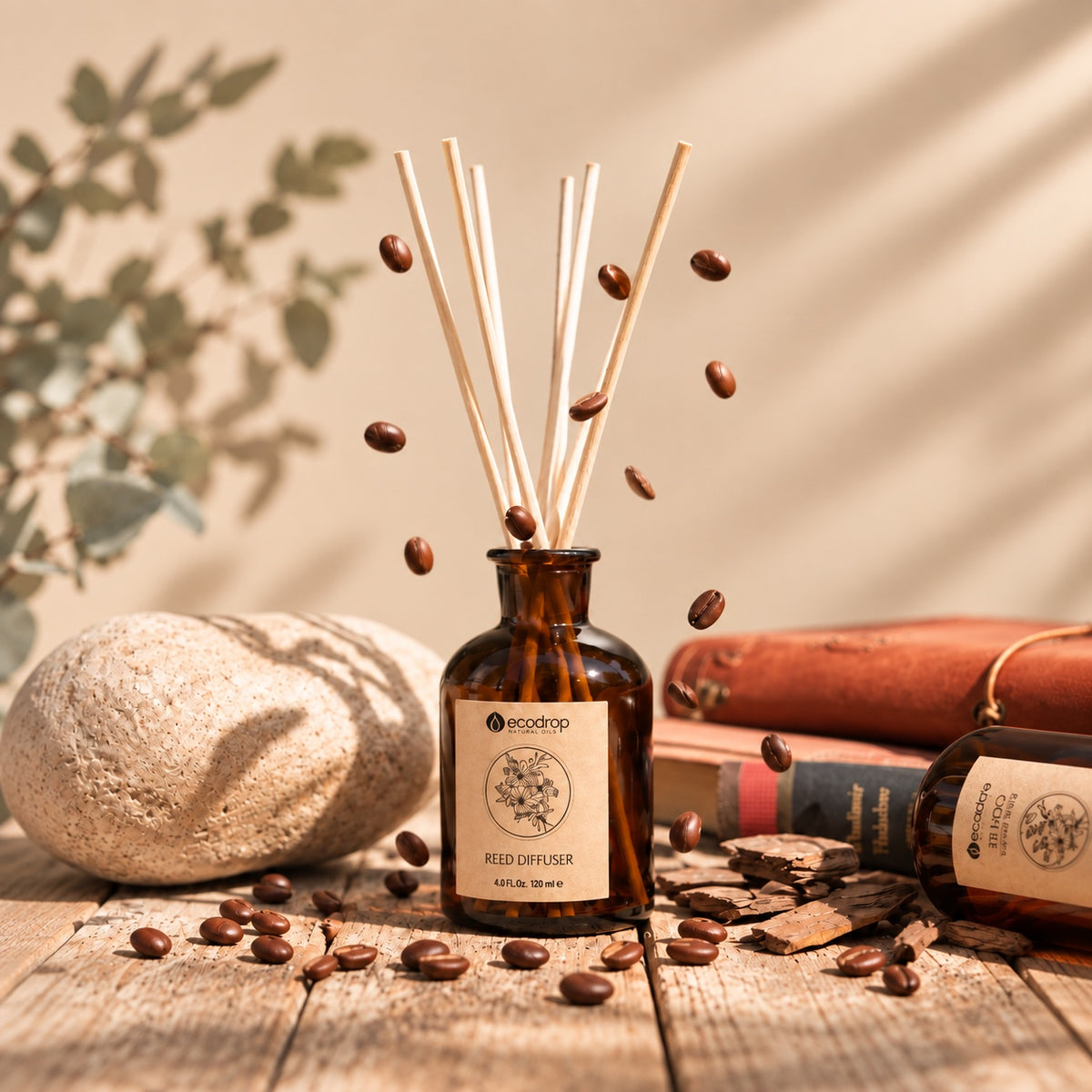 Ecodrop coffee-scented reed diffuser with coffee beans, rocks, and leather books