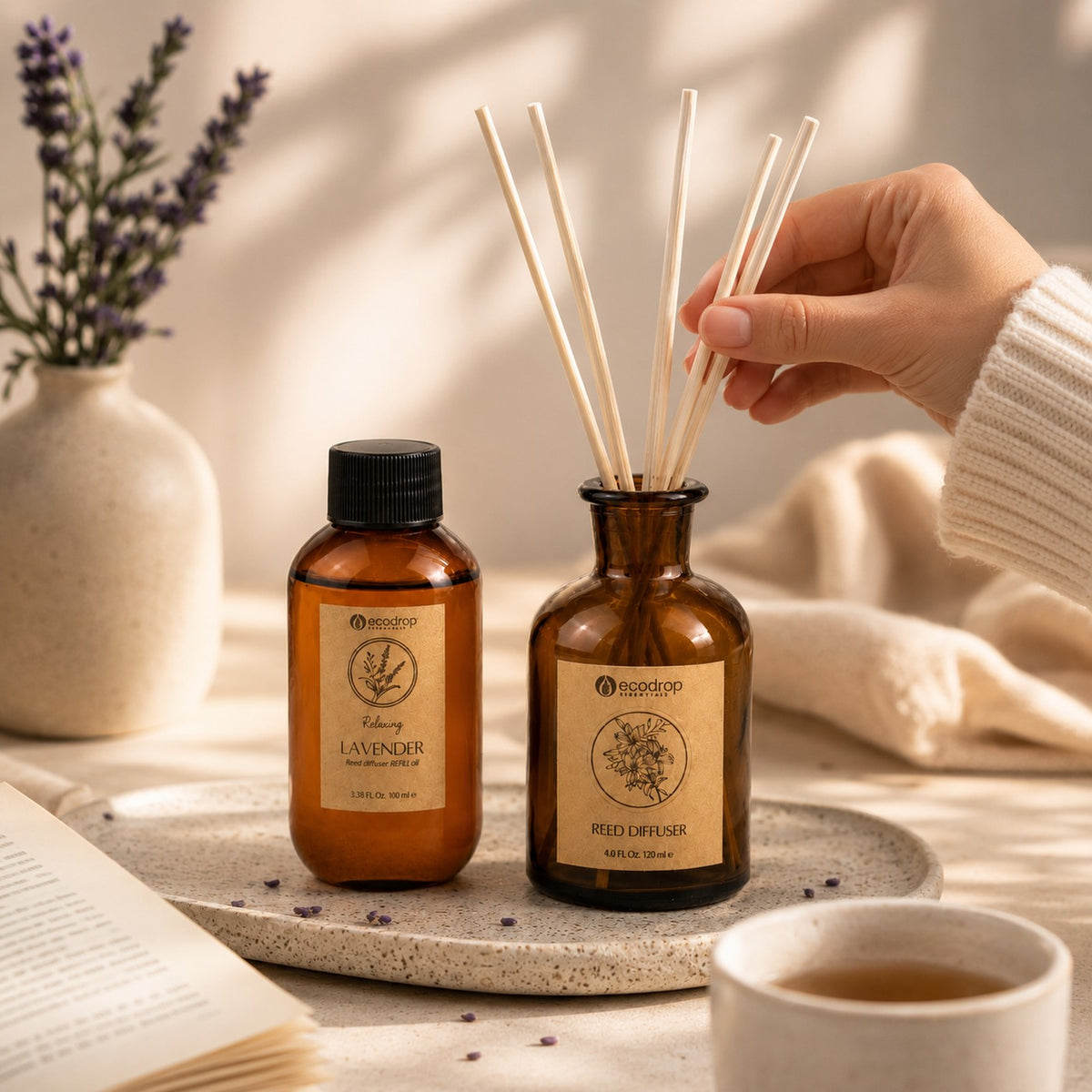 Lavender reed diffuser lifestyle - hand placing reeds beside refill bottle
