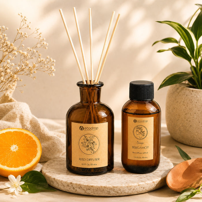 Orange Bergamot reed diffuser and refill bottle styled with orange and foliage