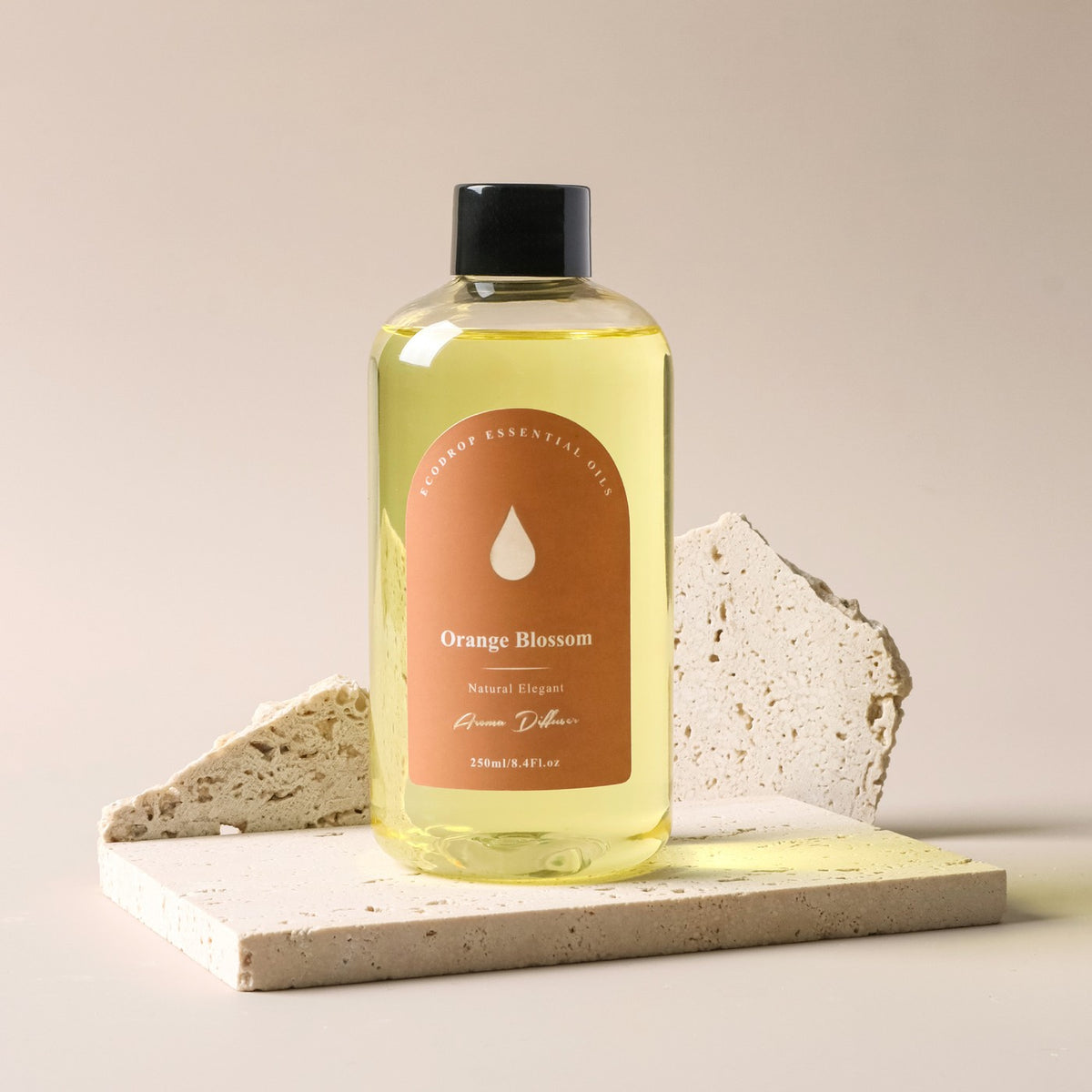 Orange Blossom reed diffuser refill bottle on travertine stone