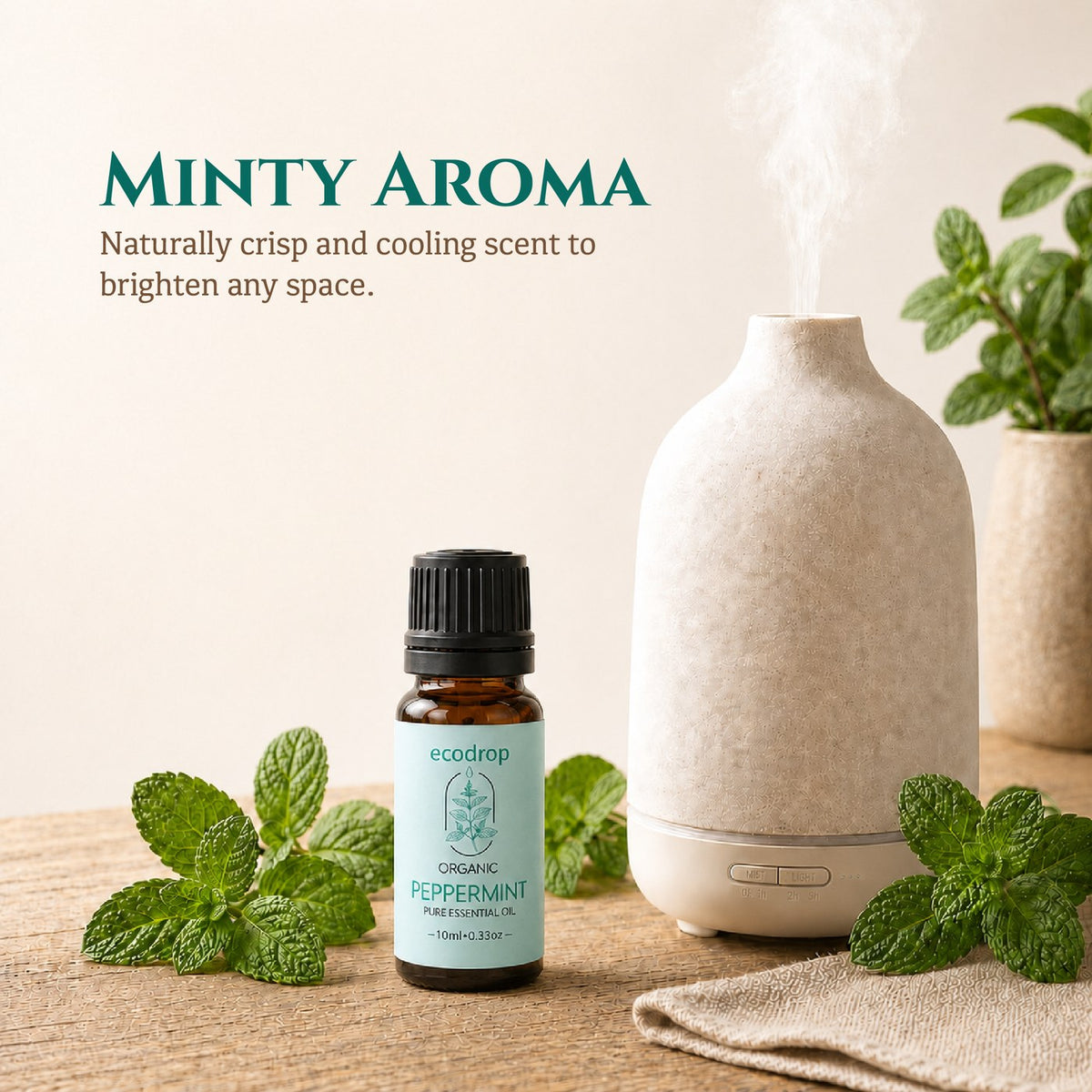 Peppermint essential oil beside a ceramic diffuser and fresh mint leaves