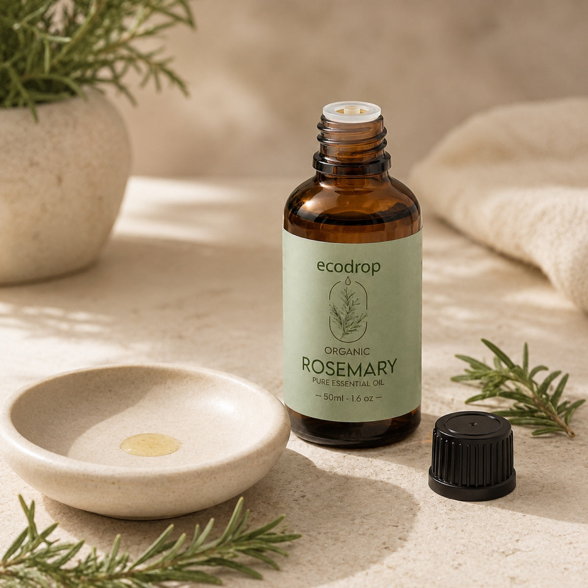 Organic Rosemary essential oil styled in a calm spa setting with rosemary
